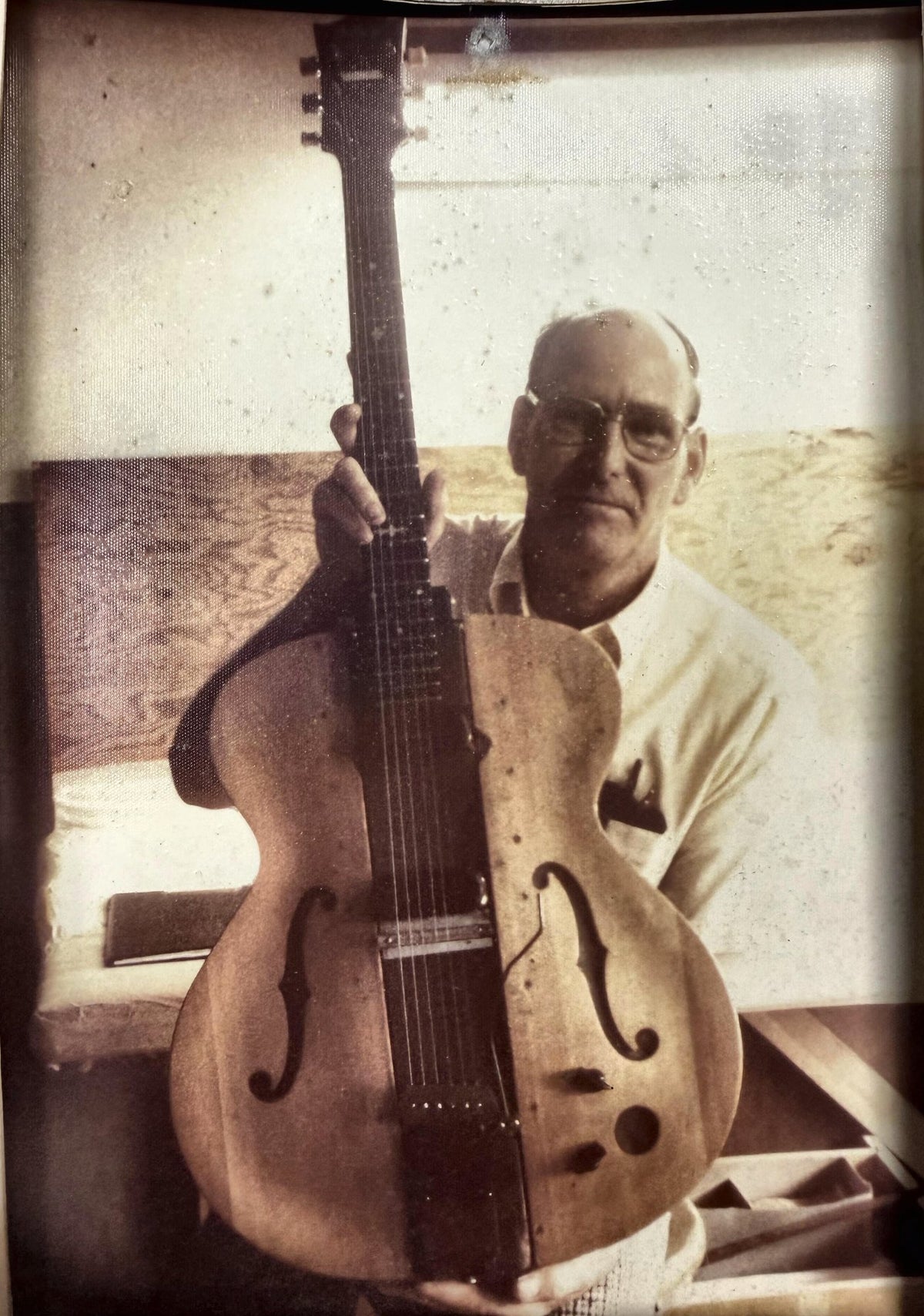 Virgil Lay holding "The Log," Les Paul's own handmade prototype.